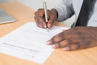 A gentleman fills out a form.