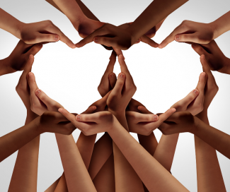 Several hands of people create two heart shapes.