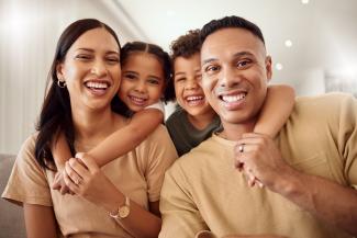 Family posing for picture smiling