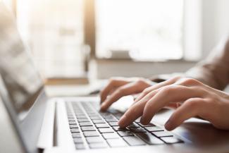 Woman typing on keyboard